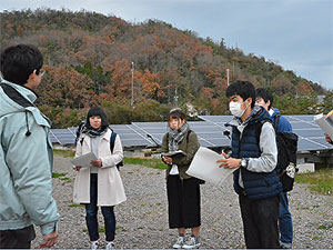 メガソーラー発電所の説明を受ける学生達